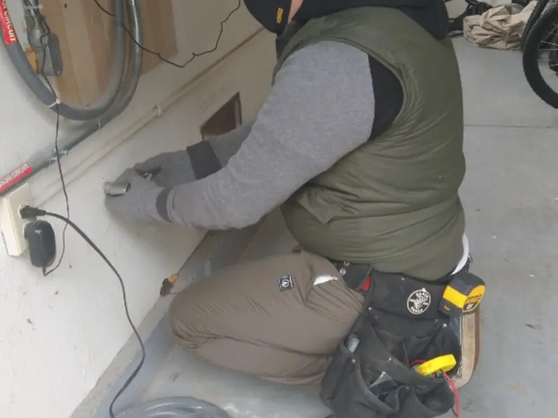 Electrician performing outlet wiring in a Loomis garage